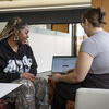 Career Coach and student meeting in the Career Center, sitting and conversing, one using a laptop.